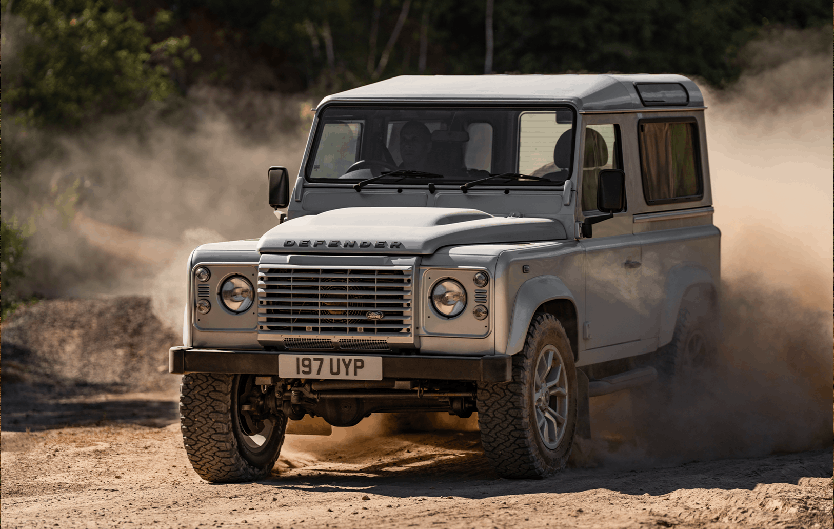 Defender interior with cream-coloured seats and large windows.