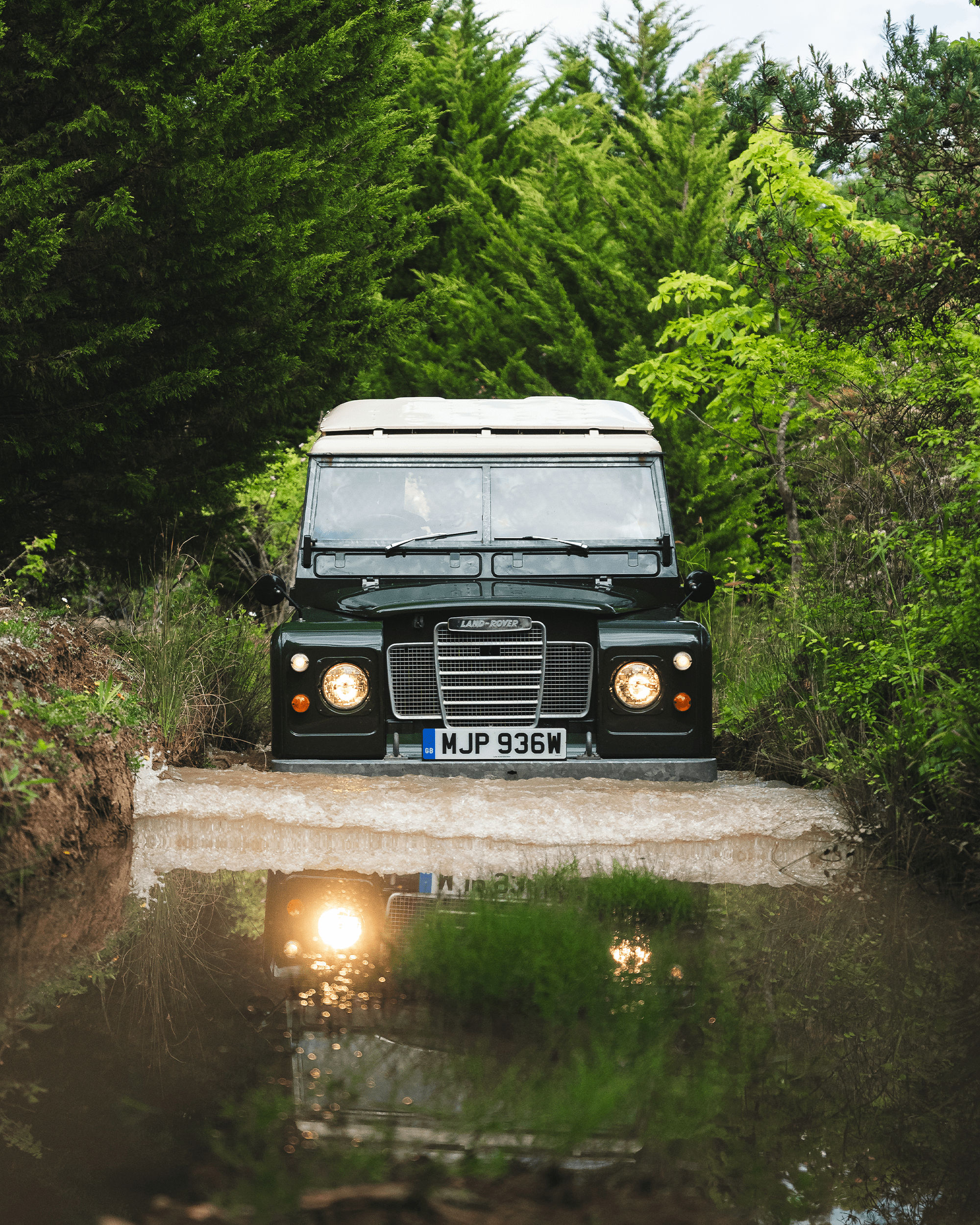 Classic Land Rovers driving on an experience day.